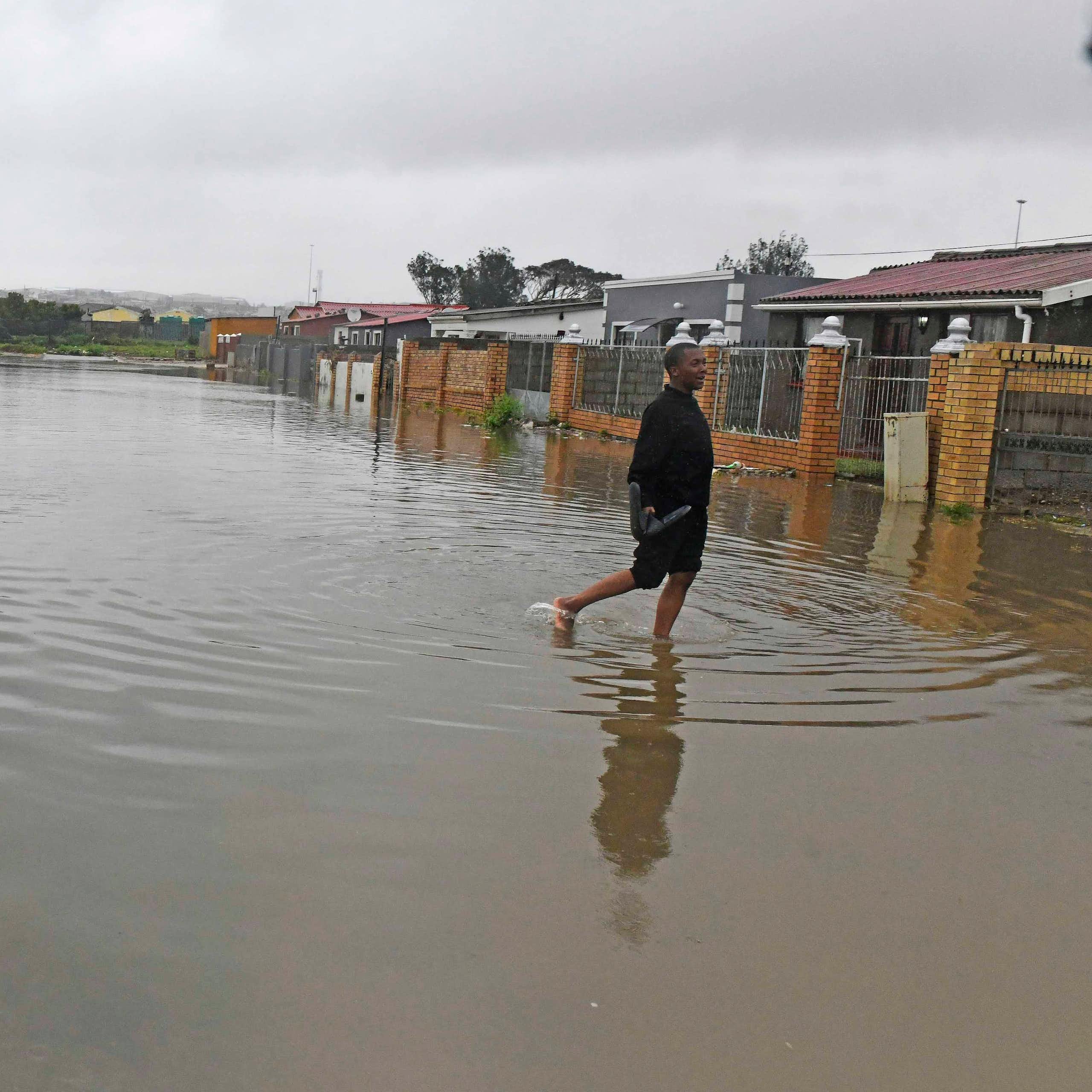A street of ordinary houses that has been flooded