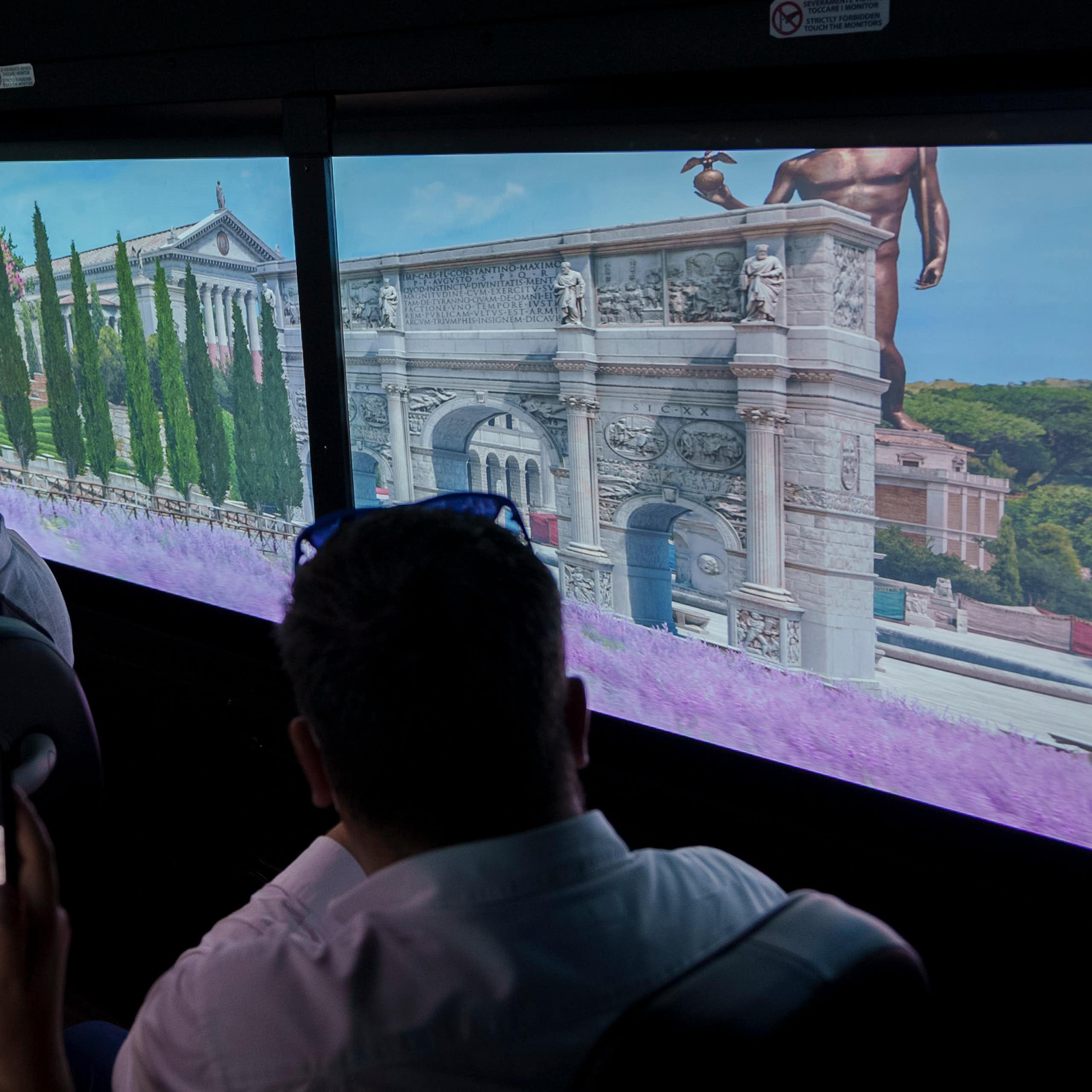 People looking at images of ancient buildings.