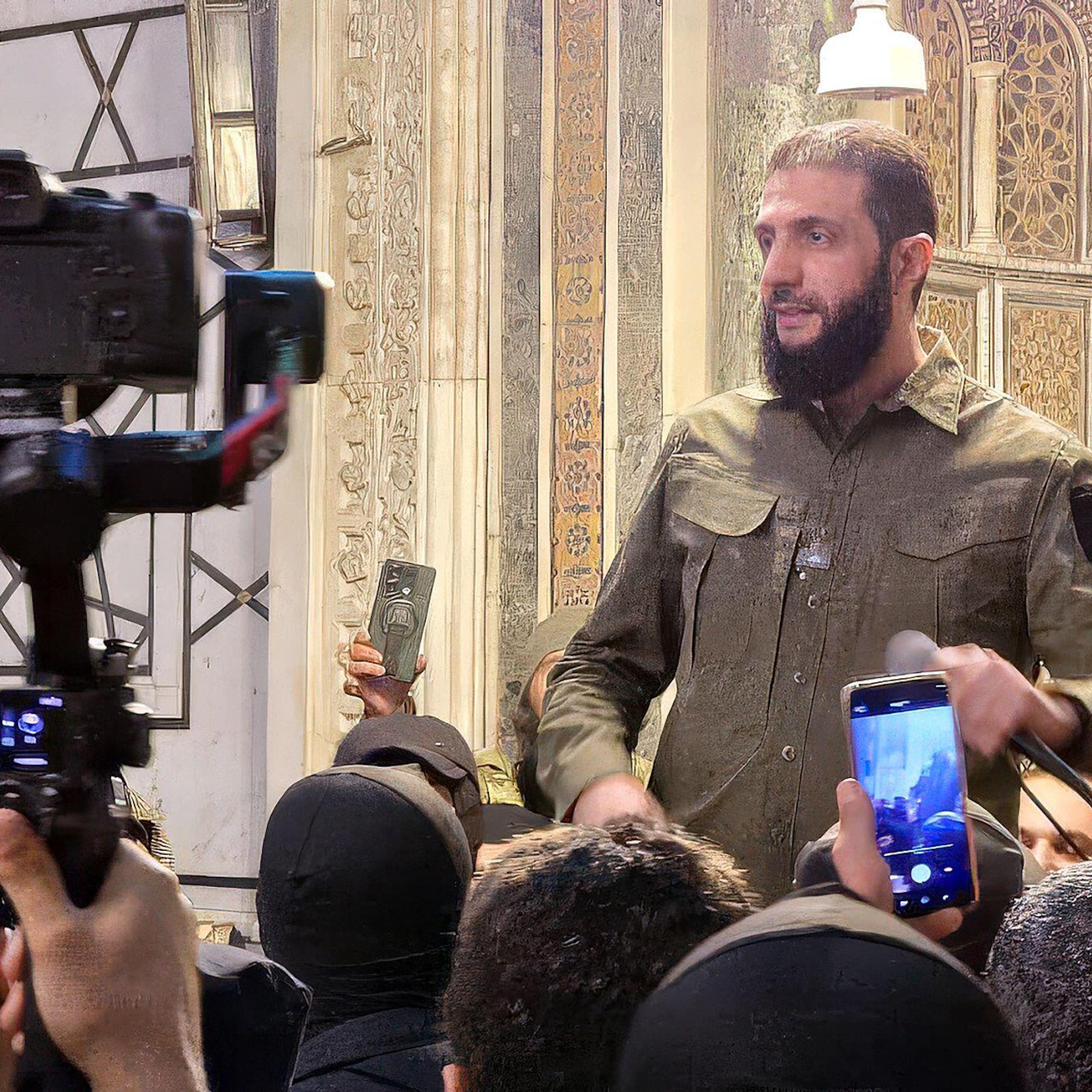 HTS leader Ahmed Al-Shara, also known as Abu Muhammad Al-Jolani talks to the press, December 2024.