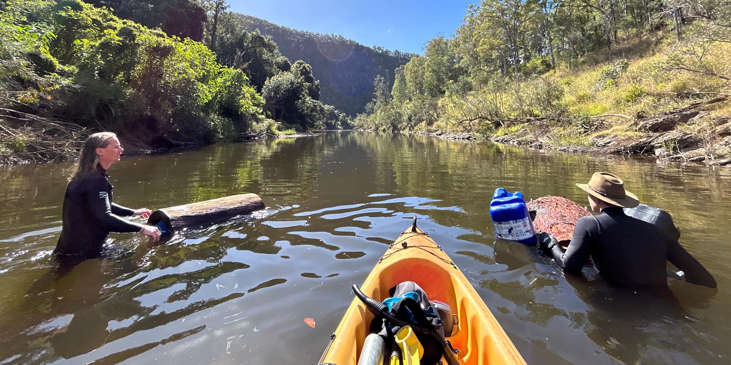 Photo showing two researchers placing hollow logs in the Mary River