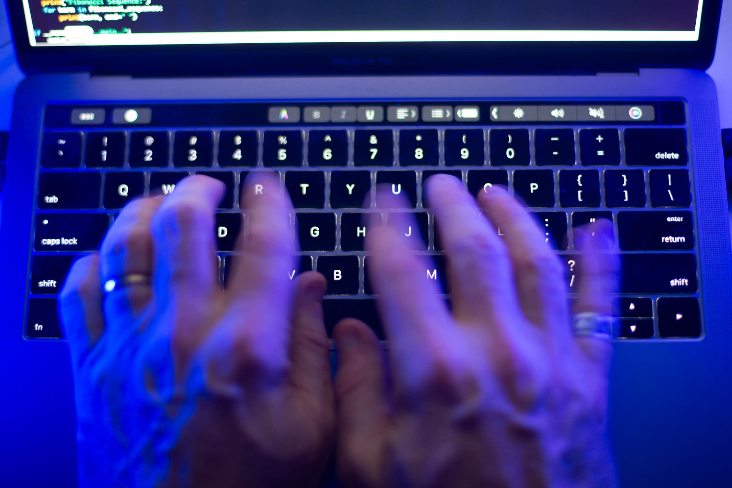Hands seen at a keyboard.