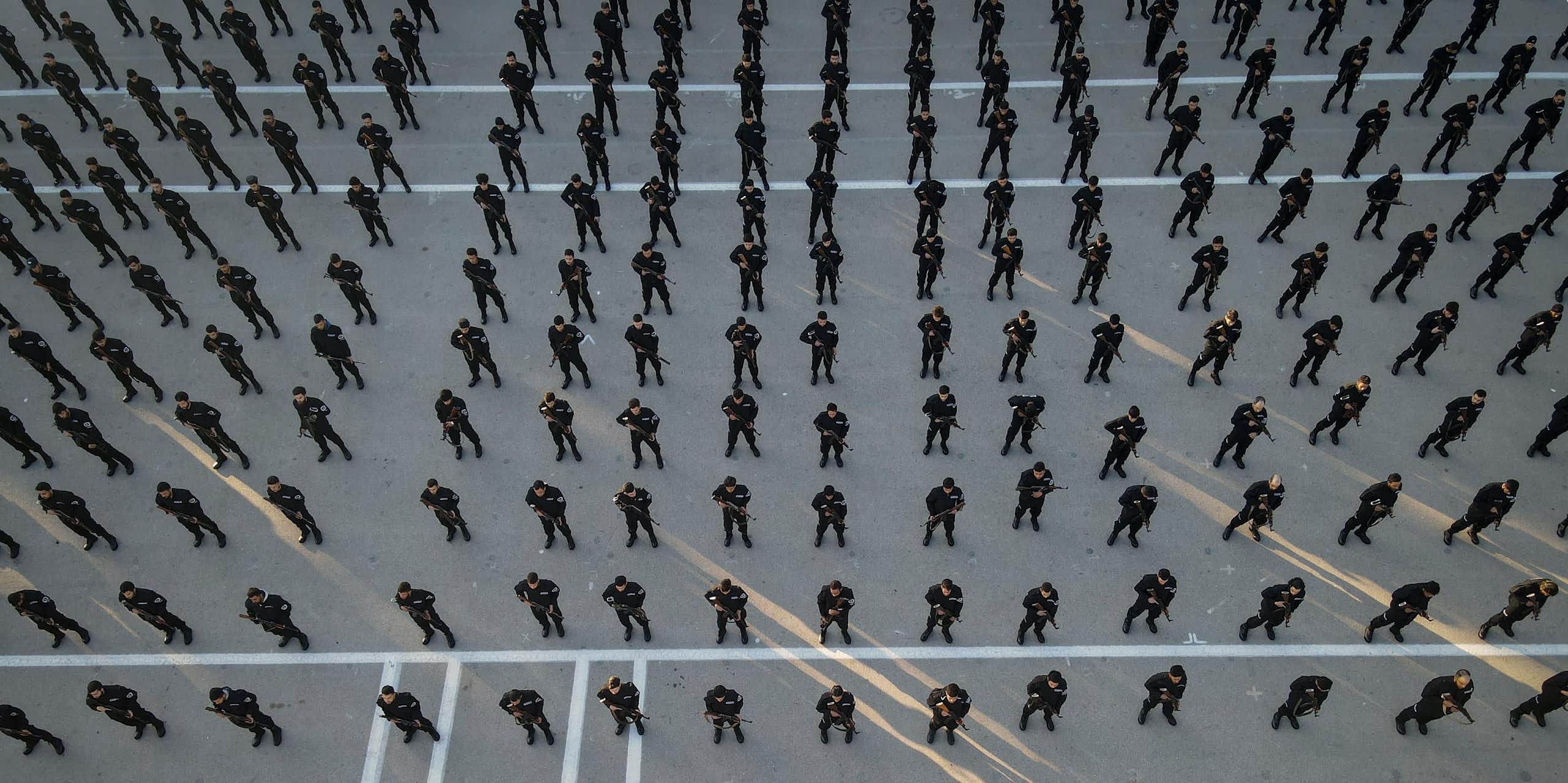 Rows of police recruits photographed from above.