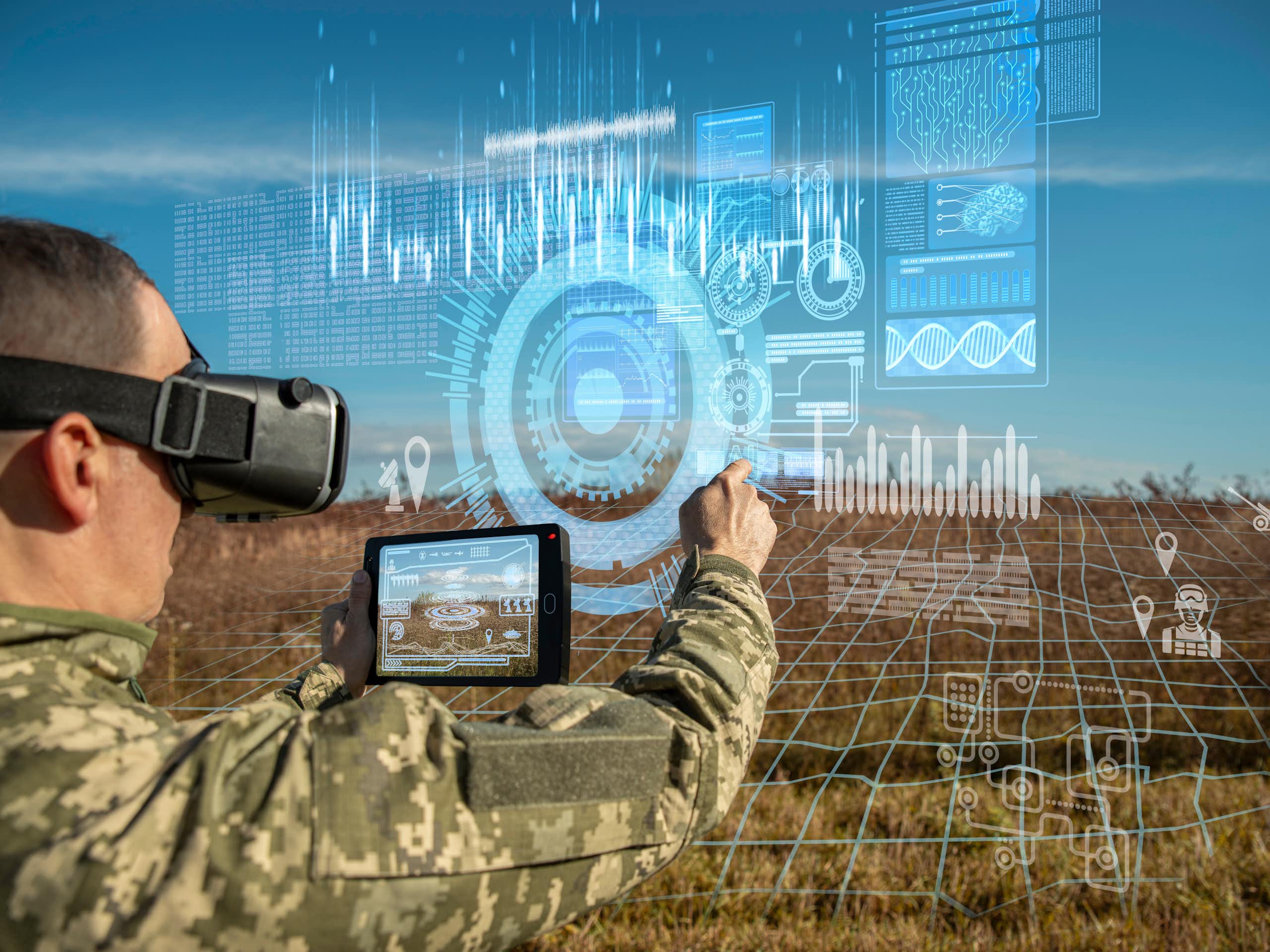 Warfare analytic operator using virtual reality glasses checking coordination of the military team with tablet device augmented device.