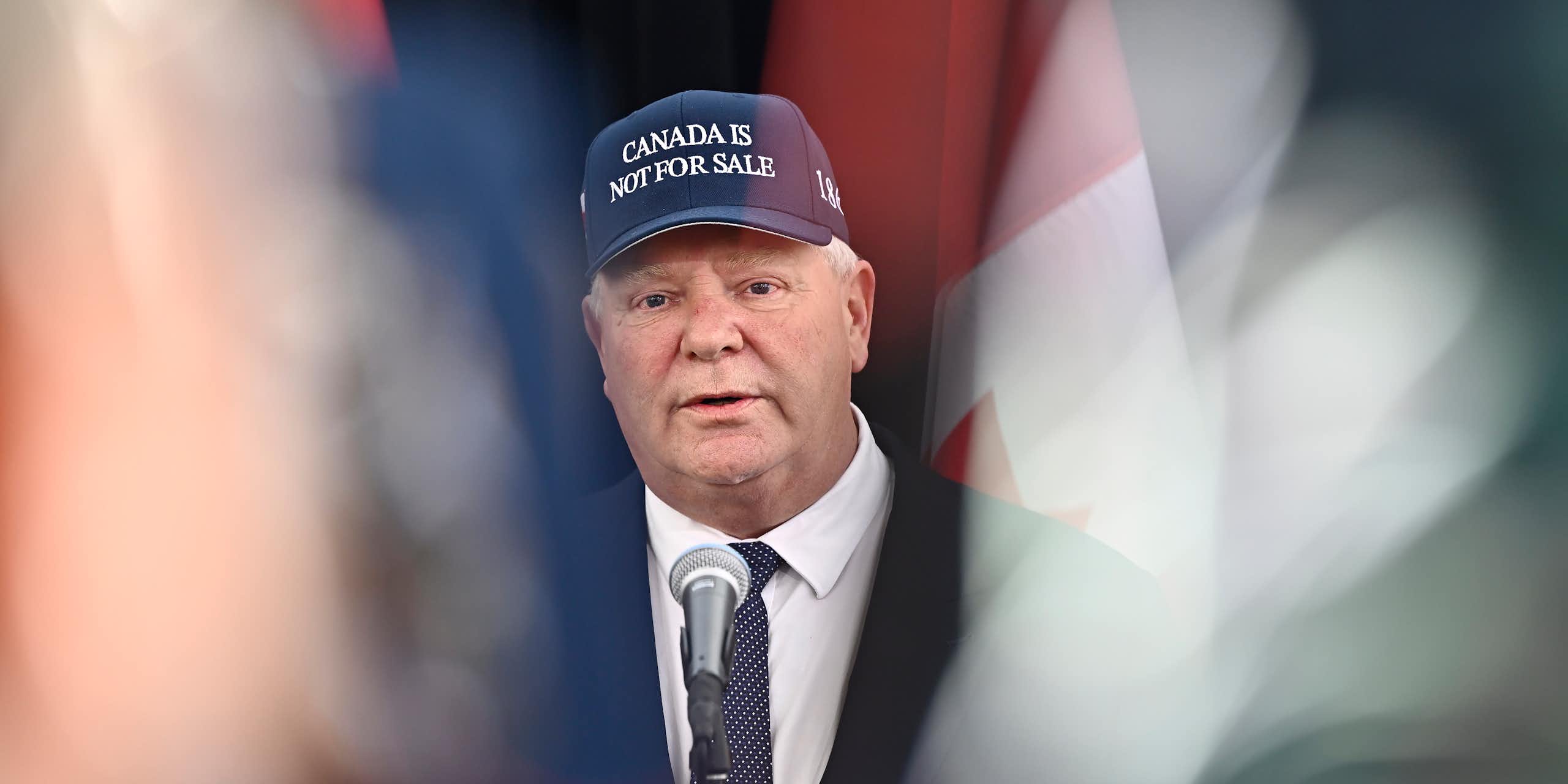 A man wearing a Canada is Not For Sale ball cap.