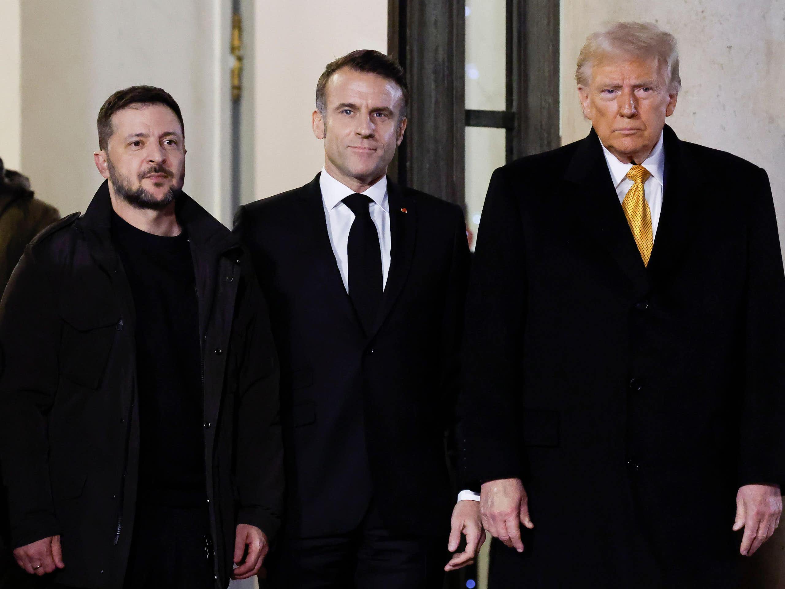 Donald Trump meets President Macron (middle) and President Zelensky (left) standing next to each other.