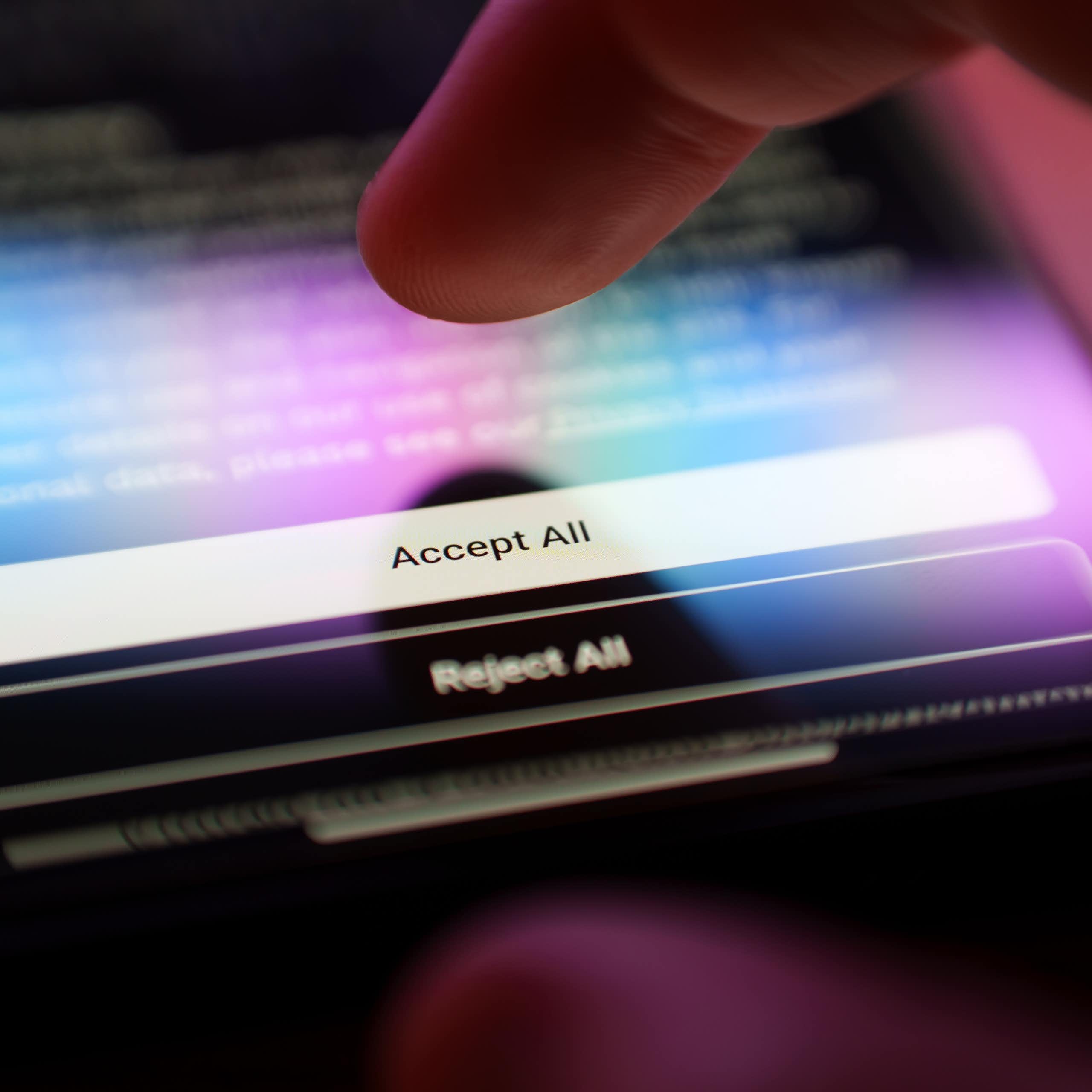 Finger about to press 'Accept All Cookies' button on a privacy policy. 