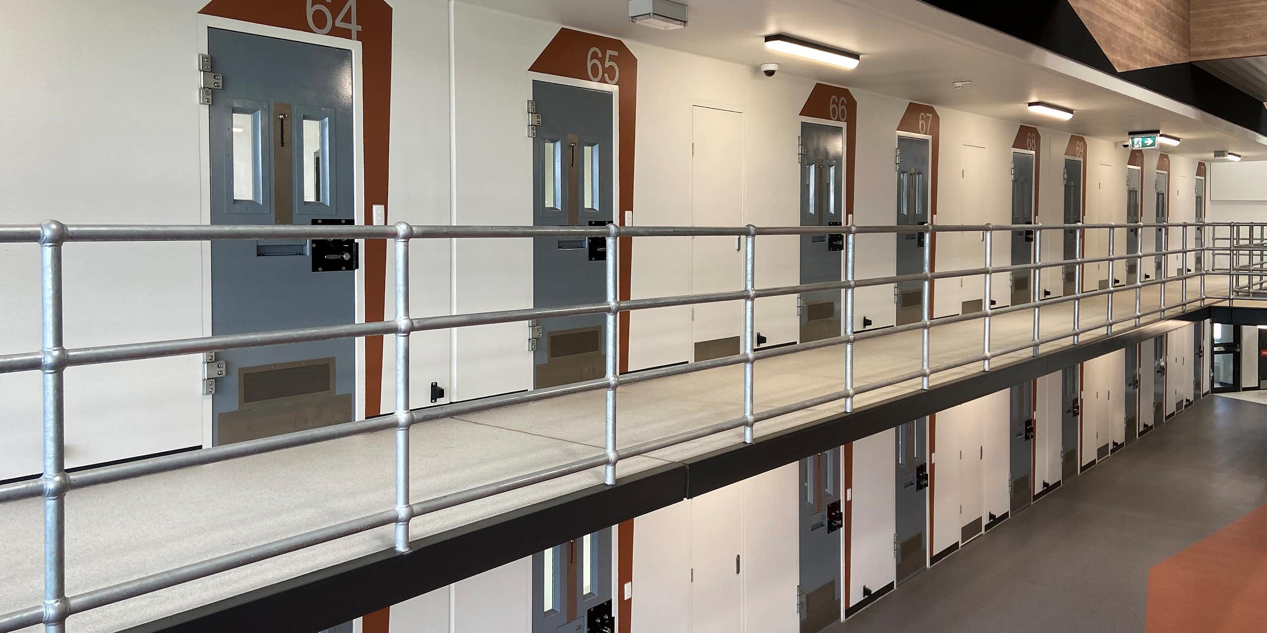 Rows of numbered prison cells 
