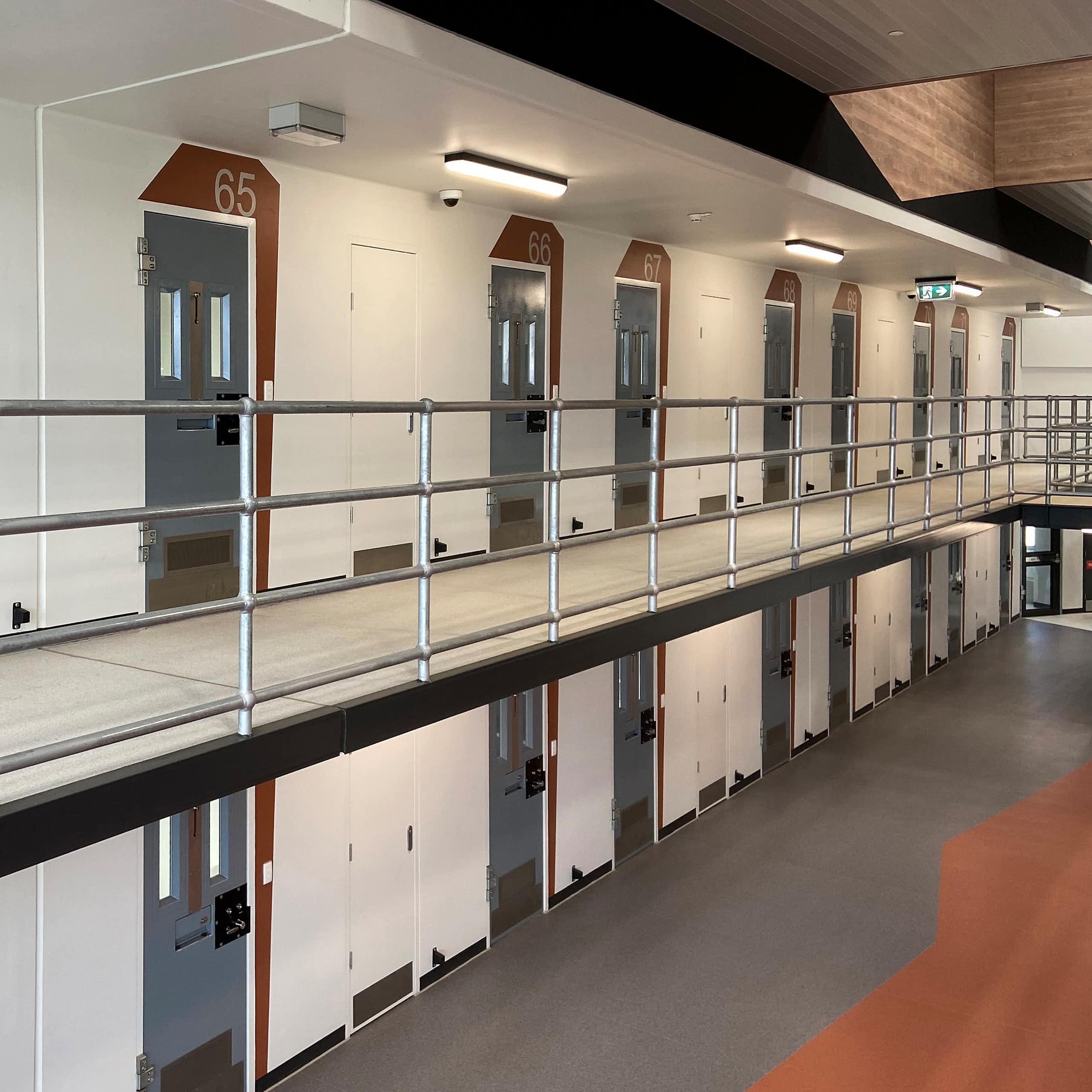 Rows of numbered prison cells 