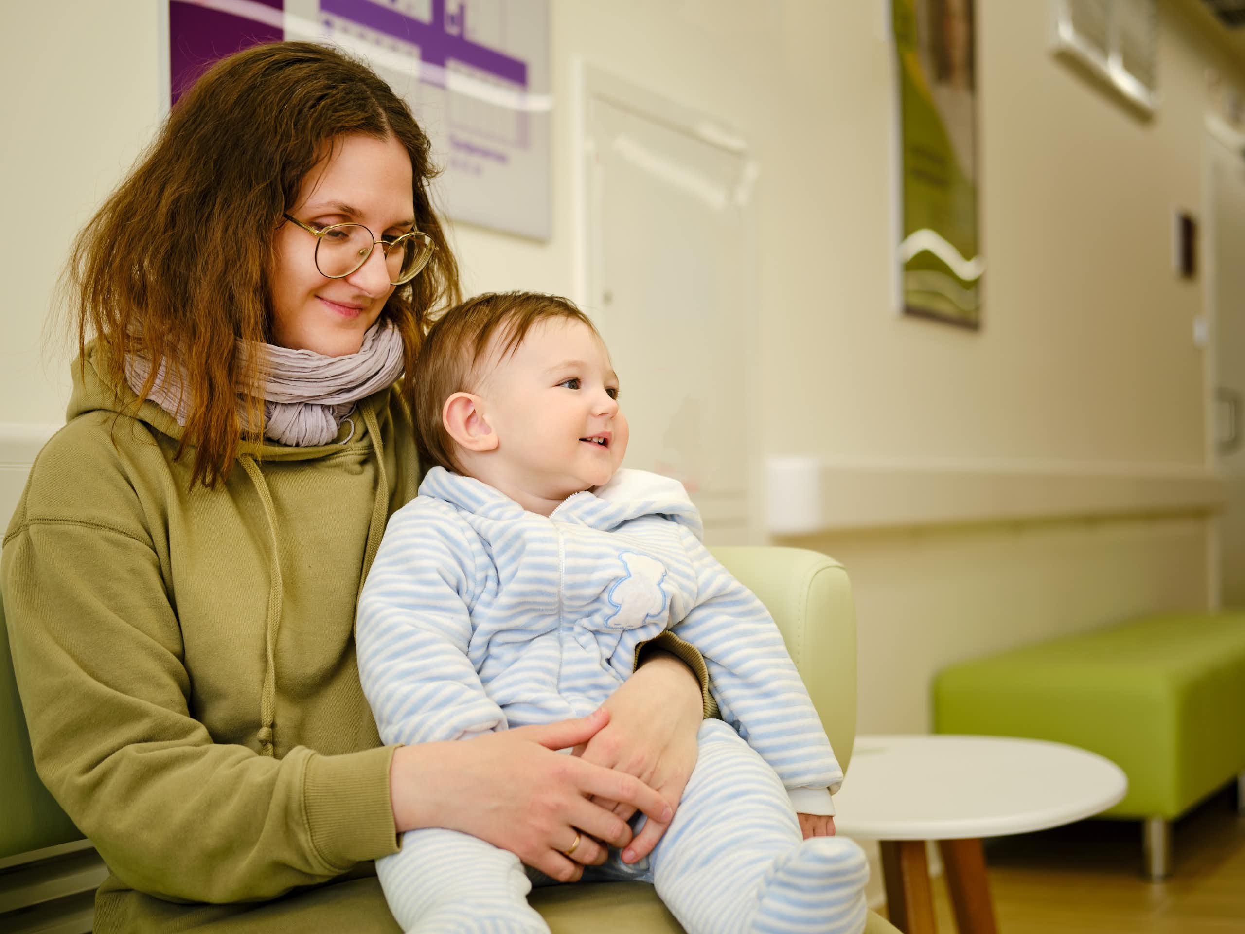 Mother holds toddler