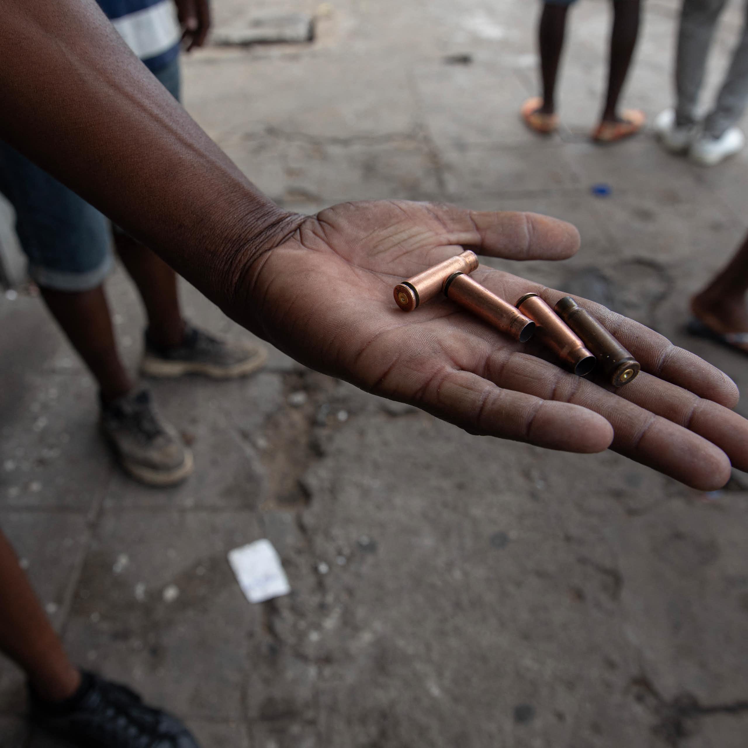 A protester shows bullet casings allegedly fired by police during a protest in Maputo on