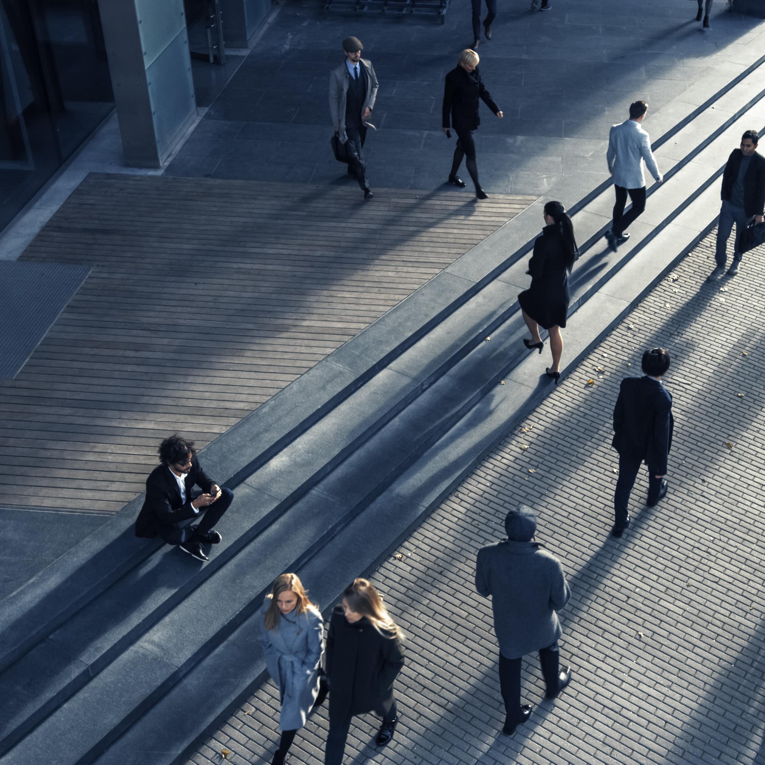 Business people seen from above commuting to work in the morning