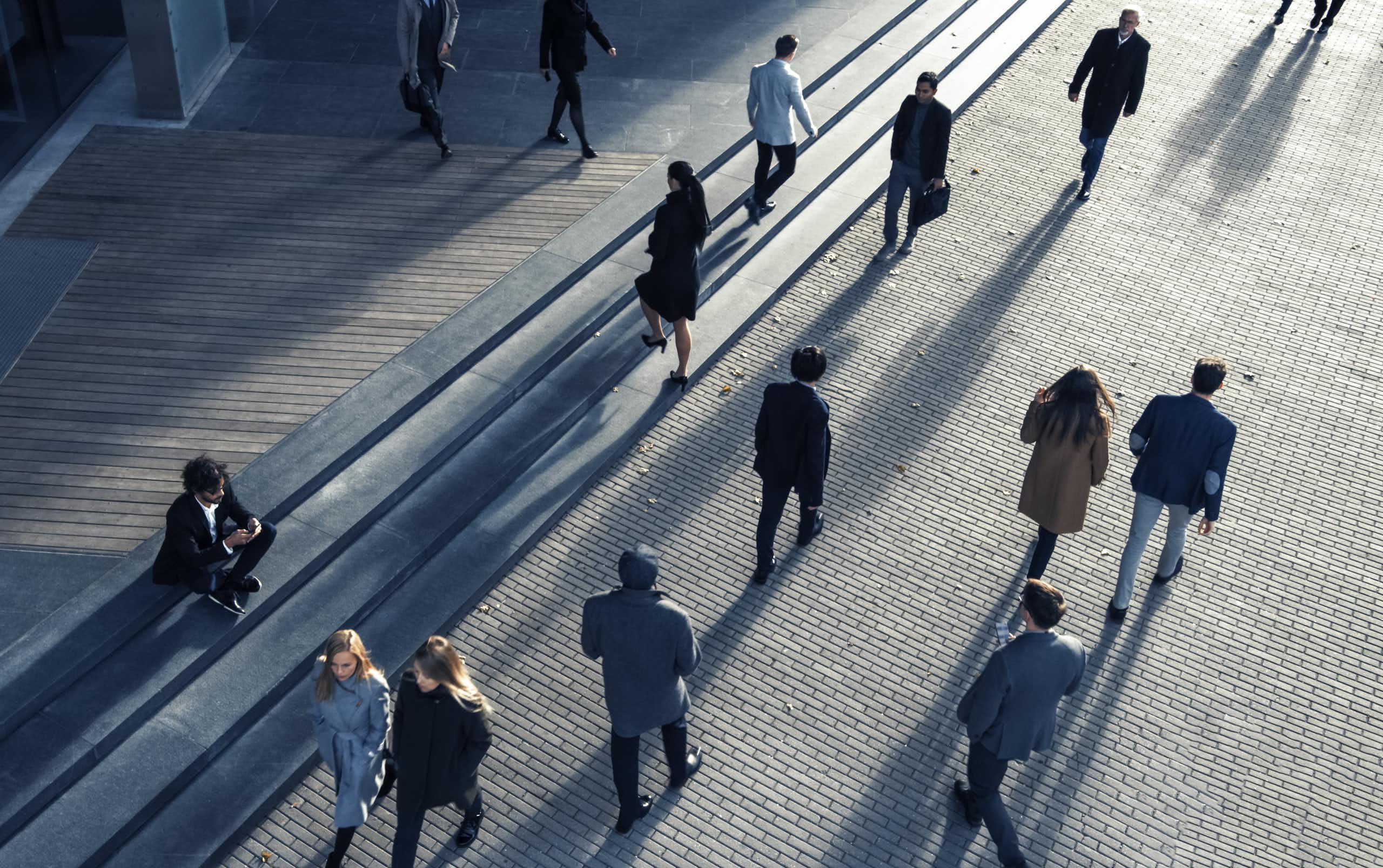 Business people seen from above commuting to work in the morning